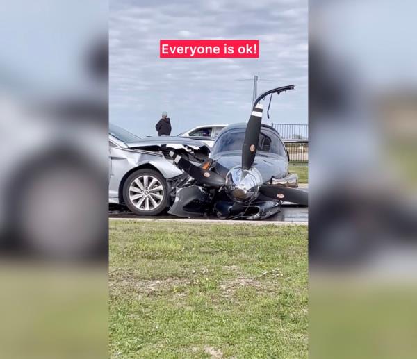 Detail shot of the damaged front-ends of a single-engine plane and the silver sedan it crashed into.