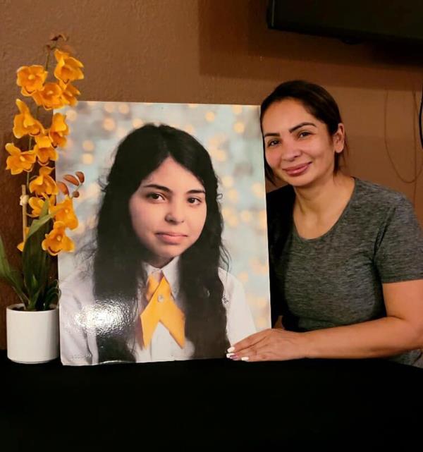 Alicia Navarro's mother stands with a photo of her then-missing daughter. 