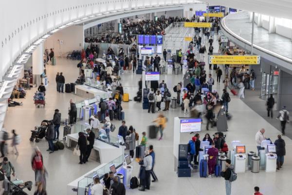 A photo of travelers inside JFK Airport.