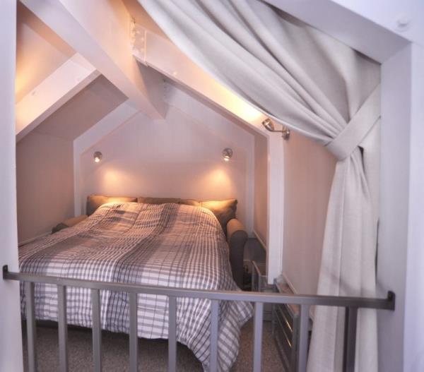 The loft bedroom with curtains. 