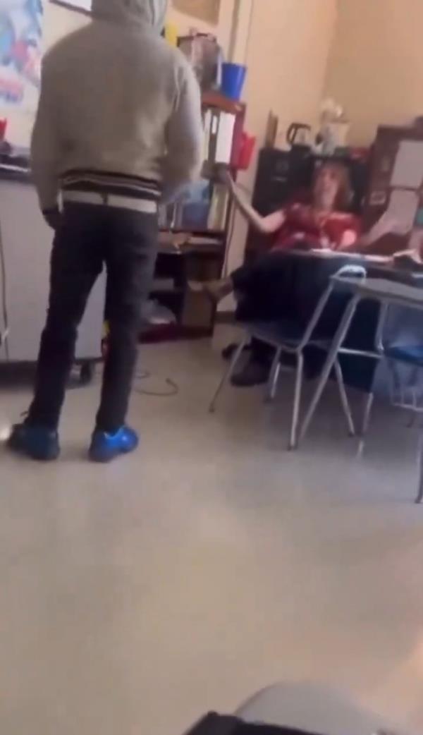 After the initial impact, the teacher seemed unfazed by the slap as the student co<em></em>ntinued to run his mouth.