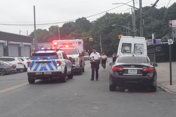 A shot of cops outside the crime scene on Faragut Road.