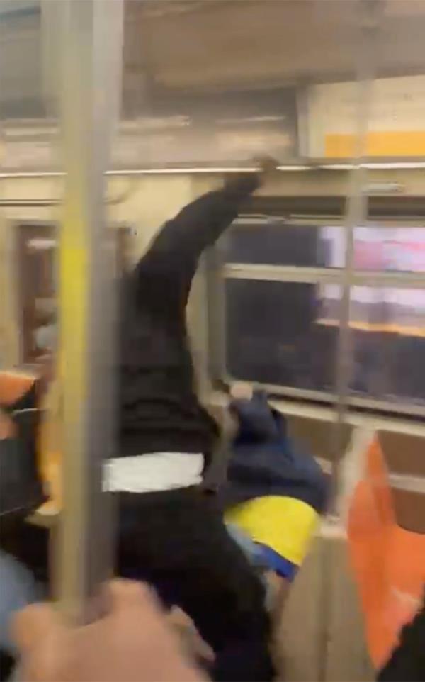 As the two were fighting, a woman on the train stabbed the 36-year-old in the back, making him bleed.