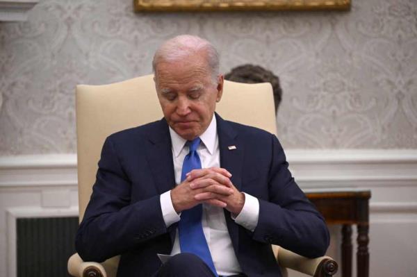 Joe Biden in the Oval Office looking down