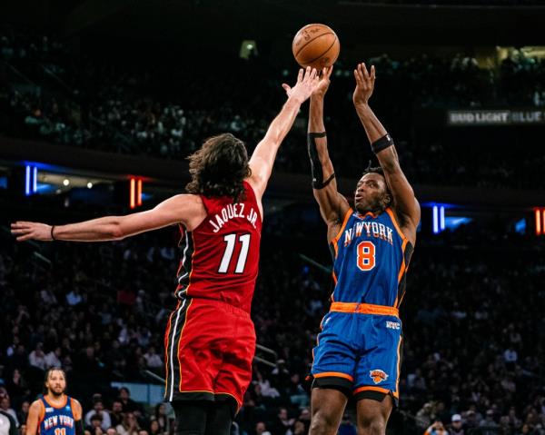 Knicks forward OG Anunoby (8) shoots over Miami Heat guard Jaime Jaquez Jr. (11) during the second half of an NBA basketball game.