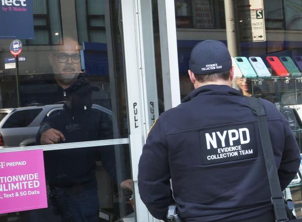 Gurpreet Singh and NYPD Evidence Team at the crime scene of 'Top in Town' Wireless store wher<em></em>e owner Kunwarjee Singh was allegedly robbed and shot.
