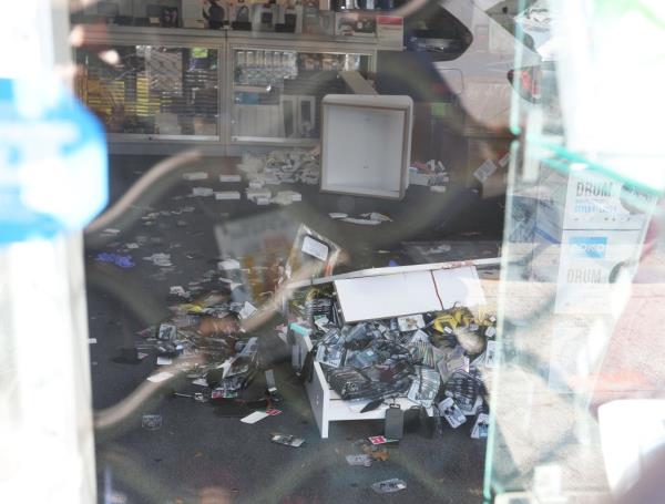 Crime scene at Top in Town wireless store with disarray from a robbery and shooting, victim Kunwarjee Singh recovering