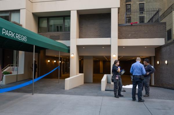Witnesses said the woman threw herself off the building but her body hit a fence on the way day, leaving her decapitated and shirtless.