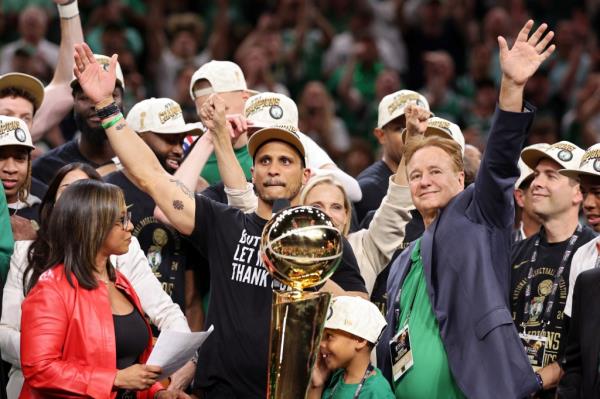 Head coach Joe Mazzulla of the Boston Celtics holds the Larry O'Brien champio<em></em>nship trophy after beating the Dallas Mavericks in Game Five of the 2024 NBA Finals at TD Garden on June 17, 2024 in Boston, Massachusetts.  