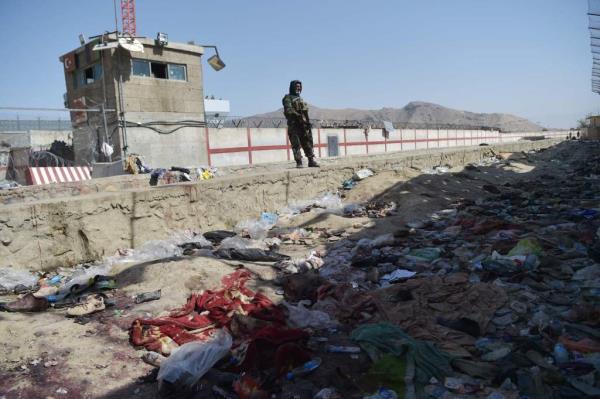 A Taliban fighter near the scene of the bombing at the airport.
