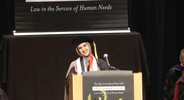Fatima Mousa Mohammed speaking at a podium during her commencement speech 