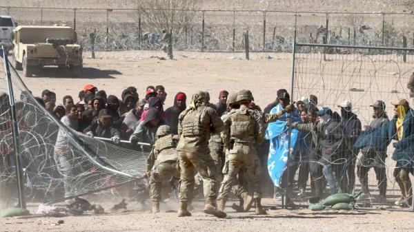 Migrants tear through border wire and overpower natio<em></em>nal guardsmen deployed to the border by the State of Texas.