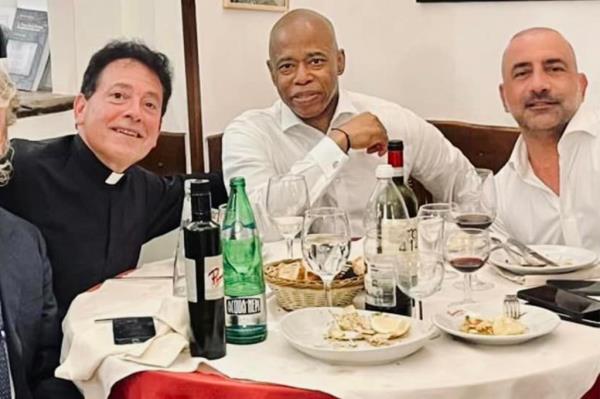Mayor Eric Adams, Frank Carone, and Msgr Jamie Gigantiello at a table in St. Peter's Basilica, Vatican Rome, with food and wine, dated May 11, 2024.