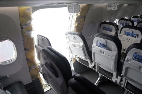 The fuselage plug area of Alaska Airlines Flight 1282 Boeing 737-9 MAX, which was forced to make an emergency landing with a gap in the fuselage, is seen during its investigation by the Natio<em></em>nal Transportation Safety Board (NTSB) in Portland, Oregon. 