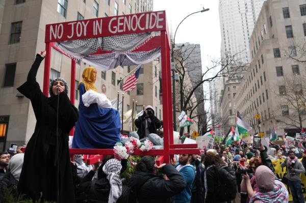 Pro-Palestine protestors gather for an All Out On Christmas For Gaza rally near the Rockefeller Center Christmas Tree on, December 25, 2023.