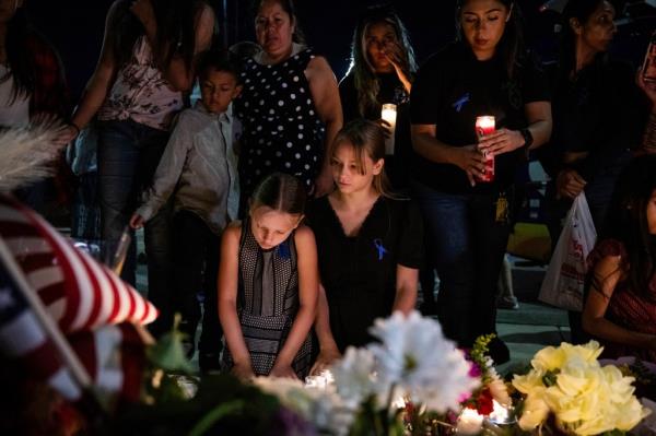 People gather for a vigil for Cl<em></em>inkunbroomer at the Palmdale Sheriff's Station on Sunday.