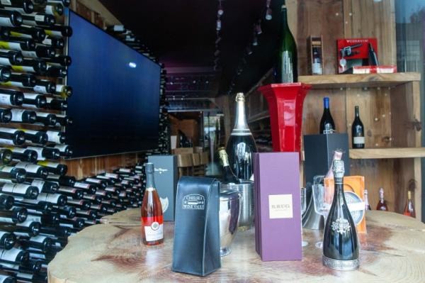 Bottles on display on a table inside the wine store.