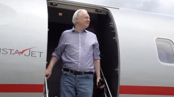 Julian Assange disembarks from a plane in Bangkok, Thailand on June 25.