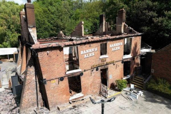 PABest The burnt out remains of The Crooked House pub near Dudley. A fire gutted the 18th century pub just days after it was sold to a private buyer. Firefighters and police were called to the pub in Himley, West Midlands, at 10.45pm on Saturday. The blaze was extinguished and no-one was reported to have been injured, Staffordshire Police said. Picture date: Mo<em></em>nday August 7, 2023. PA Photo. See PA story FIRE Crooked. Photo credit should read: Jacob King/PA Wire