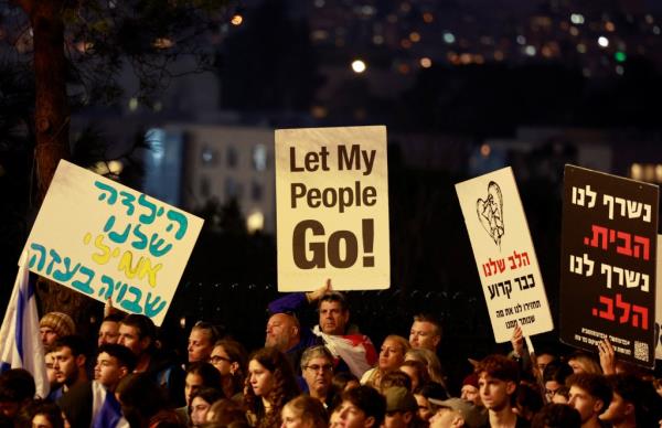 A crowd of people protesting in Israeli. 