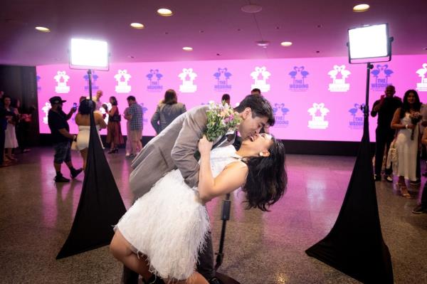 Steven Mical dips and kisses fiancee Johanna Lee while the Brooklyn couple checked out a 360 photo booth prior to the ceremony.