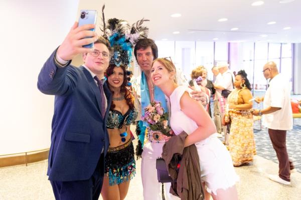 Prior to the ceremony, Louis Gros and May Lucie Meyer take a selfie with Elvis and a Vegas showgirl. Couples celebrate their vows at The Wedding: New York's Biggest Day at Lincoln Center. 