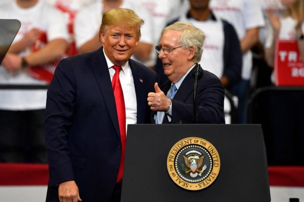 President Do<em></em>nald Trump, left, and Senate Majority Leader Mitch McCo<em></em>nnell of Ky., greet each other during a campaign rally in Lexington, Ky., Nov. 4, 2019.