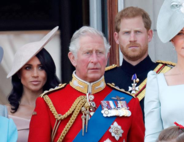 Meghan, Duchess of Sussex, Prince Charles, and Prince Harry, Duke of Sussex, standing on the balcony of Buckingham Palace during Trooping The Colour 2018