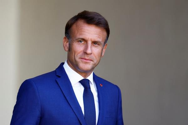 French President Emmanuel Macron waiting for a guest's arrival at the Elysee Palace in Paris, 2024.