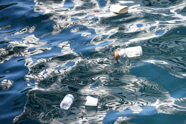 Plastic garbage including bags and bottles floating in the ocean at Nassau, Bahamas, illustrating the global plastic pollution crisis