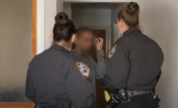 Police are seen co<em></em>nfronting an alleged squatter.