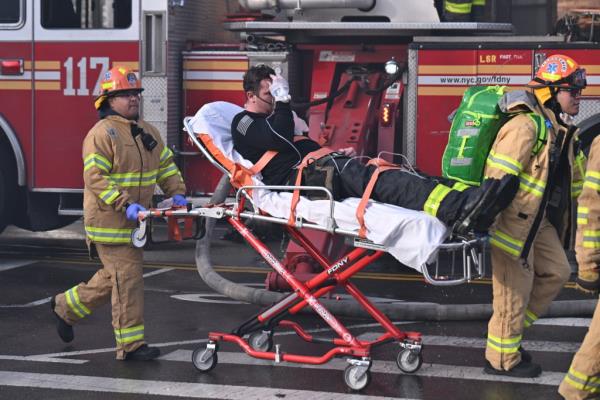 An injured firefighter is transported from the scene of the blaze at 43-09 47th Avenue  in Sunnyside.
