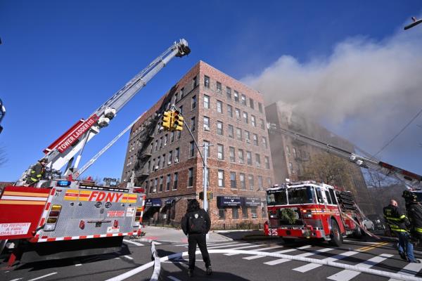 Smoke billows from an apartment building at 43-09 47th Avenue in Sunnyside during a five-alarm fire Wednesday.