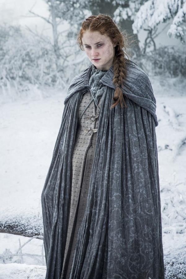 Sansa (Sophie Turner) standing in the show in a cloak looking cold and sad on 