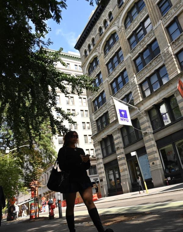 A photo of a student on her way to class at NYU in Greenwich Village.