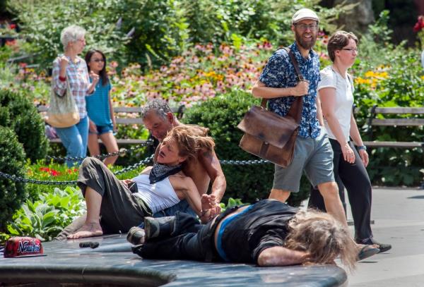 A photo showing drugged and drunk trio was spotted hanging out in the center of nearby Washington Square Park, as people walk by