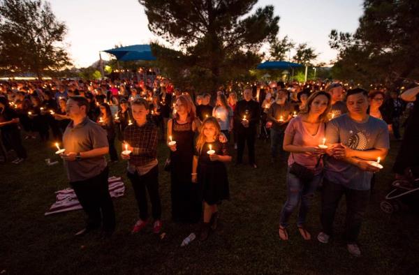 People attend a candlelight memorial for a Las Vegas Metro Police Officer who was killed during the shooting on Oct. 1, 2017.