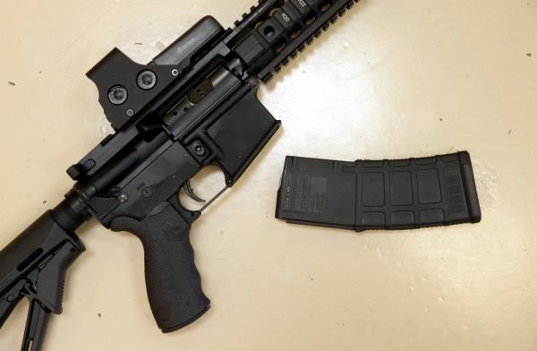 A custom-made semi-automatic hunting rifle with a high-capacity detachable magazine is displayed at a gun store in Rocklin, Calif, on Oct. 3, 2013.