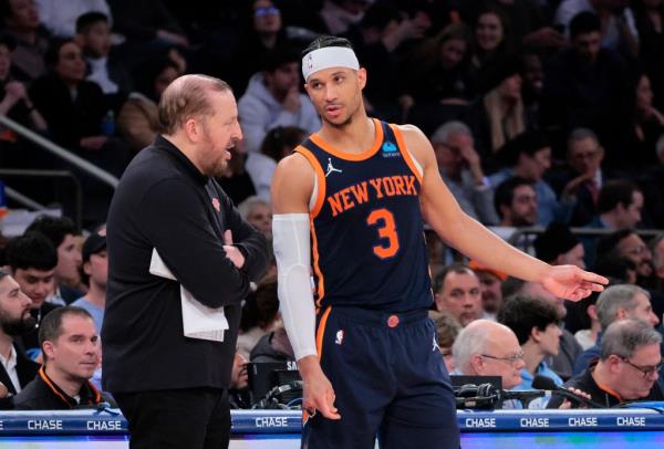 New York Knicks head coach Thibodeau speaks with guard Hart during a basketball game at Madison Square Garden.