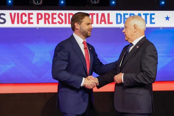 Republican vice presidential candidate, Sen. JD Vance (R-OH), and Democratic vice presidential candidate, Minnesota Gov. Tim Walz, greet each other ahead of a debate at the CBS Broadcast Center on October 1, 2024 in New York City.