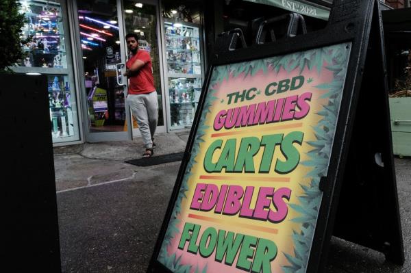 A smoke shop not authorized to sell cannabis products advertises gummies and other edible products as authorities step up a crackdown on unlicensed smoke shops June 16, 2023 in New York City.