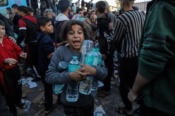 A Palestinian child receiving drinking water from a supply truck in Khan Younis on Nov. 21, 2023. The hostage deal includes allowing more humanitarian aid in to Gaza.