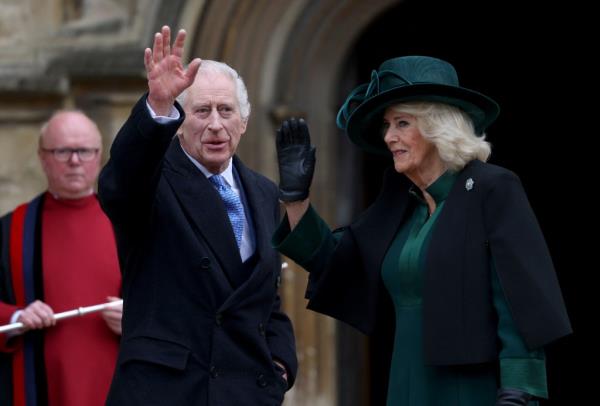 King Charles and Queen Camilla wave to the crowd before entering the Easter Mattins Service at Windsor Castle on Sunday.