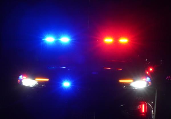 Police car with flashing lights parked in West Milford, NJ on June 15, 2024, during a murder investigation