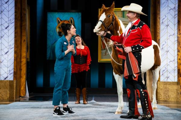 Sarah Silverman smiling at a man with a horse. 