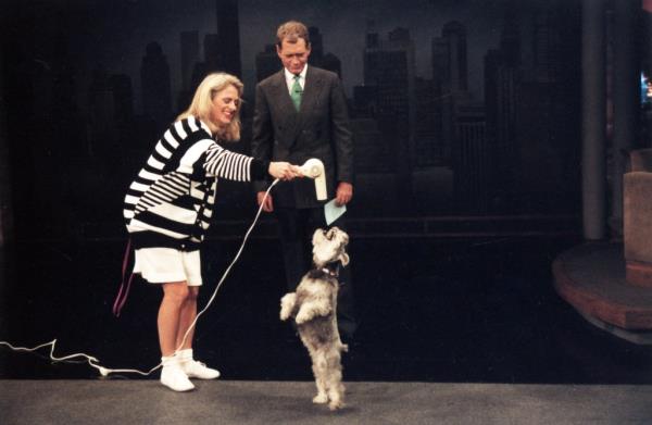 David Letterman smiling at a woman and her dog. 
