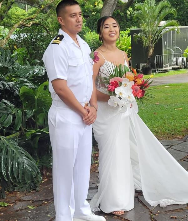 A man and woman in white dresses celebrating their wedding in Hale'iwa, O'ahu on the island of Honolulu