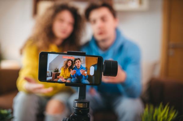 Two people in front of phone camera