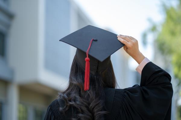 person in graduation cap and gown