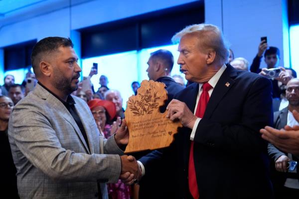 Do<em></em>nald Trump shakes hands with owner Albert Abbas as he visits The Great Commoner, Friday, Nov. 1, 2024, in Dearborn, Mich.